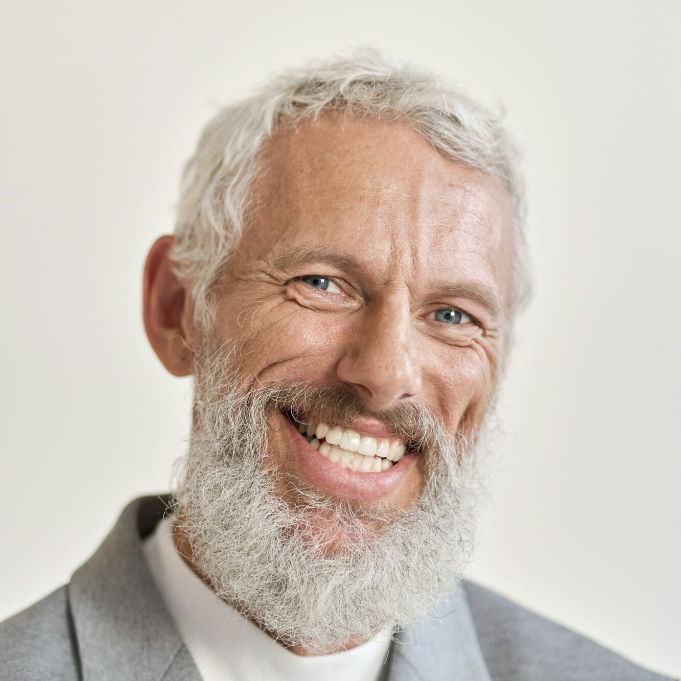 Happy old business man isolated on white, vertical headshot portrait.